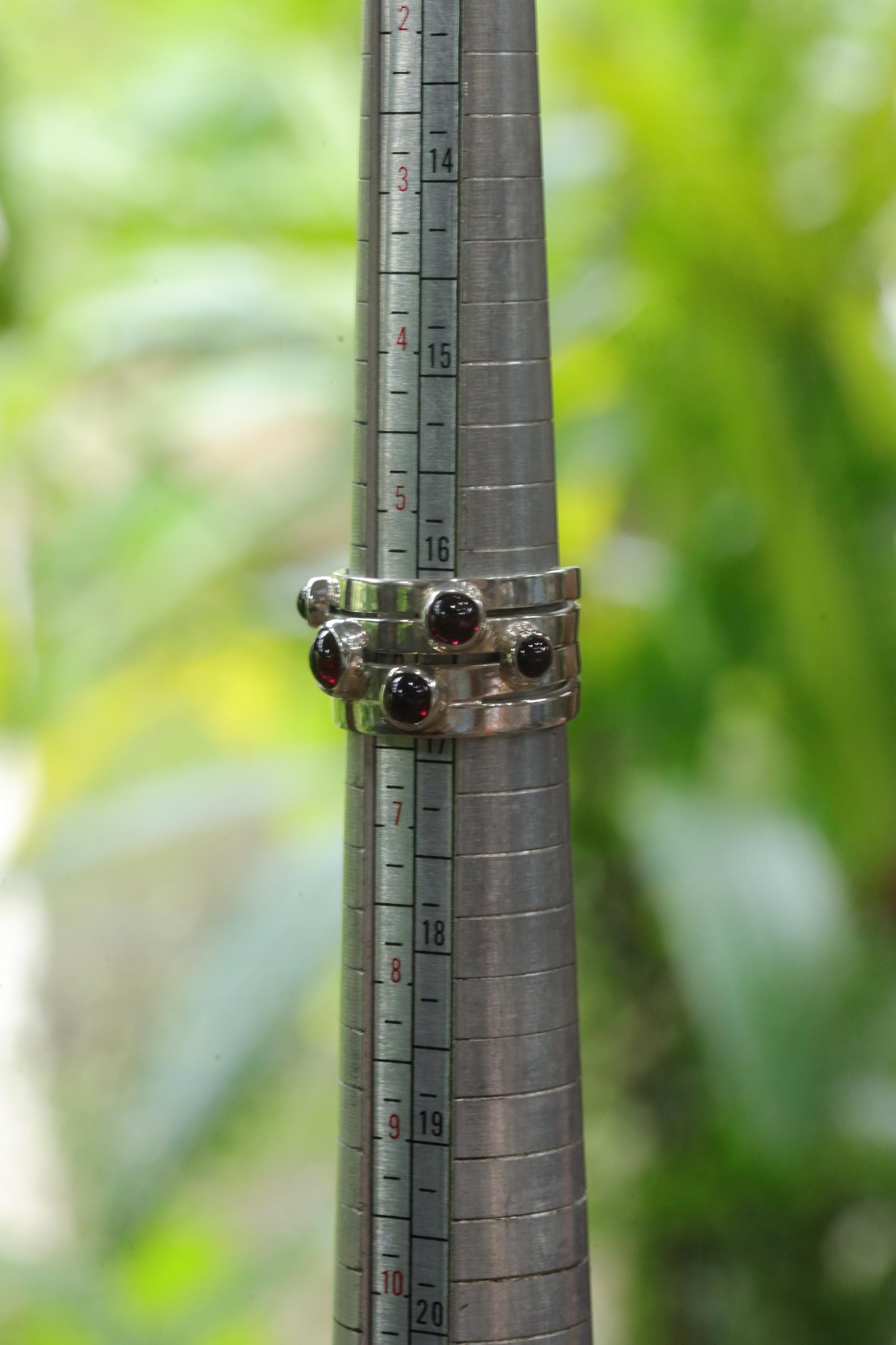 Five Stone Garnet sterling silver ring shown on mandrel for US size 6 reference.