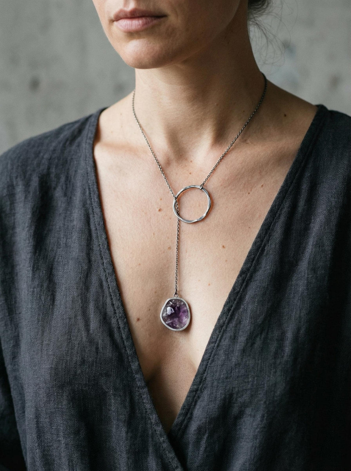Raw Amethyst oxidized sterling silver lariat necklace shown worn with long adjustable loop design.