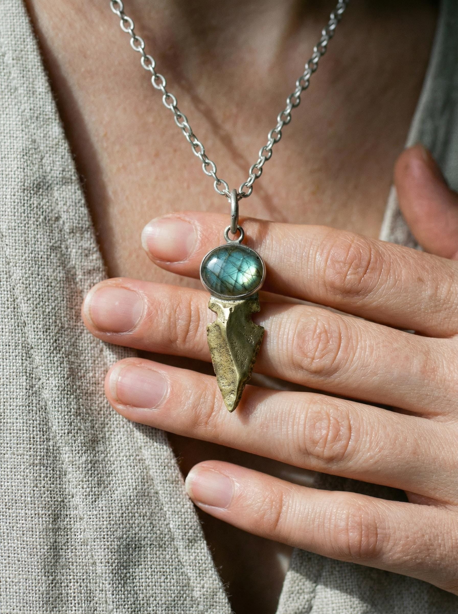 Labradorite Obsidian spearhead pendant worn on adjustable cord with sterling silver and brass setting.