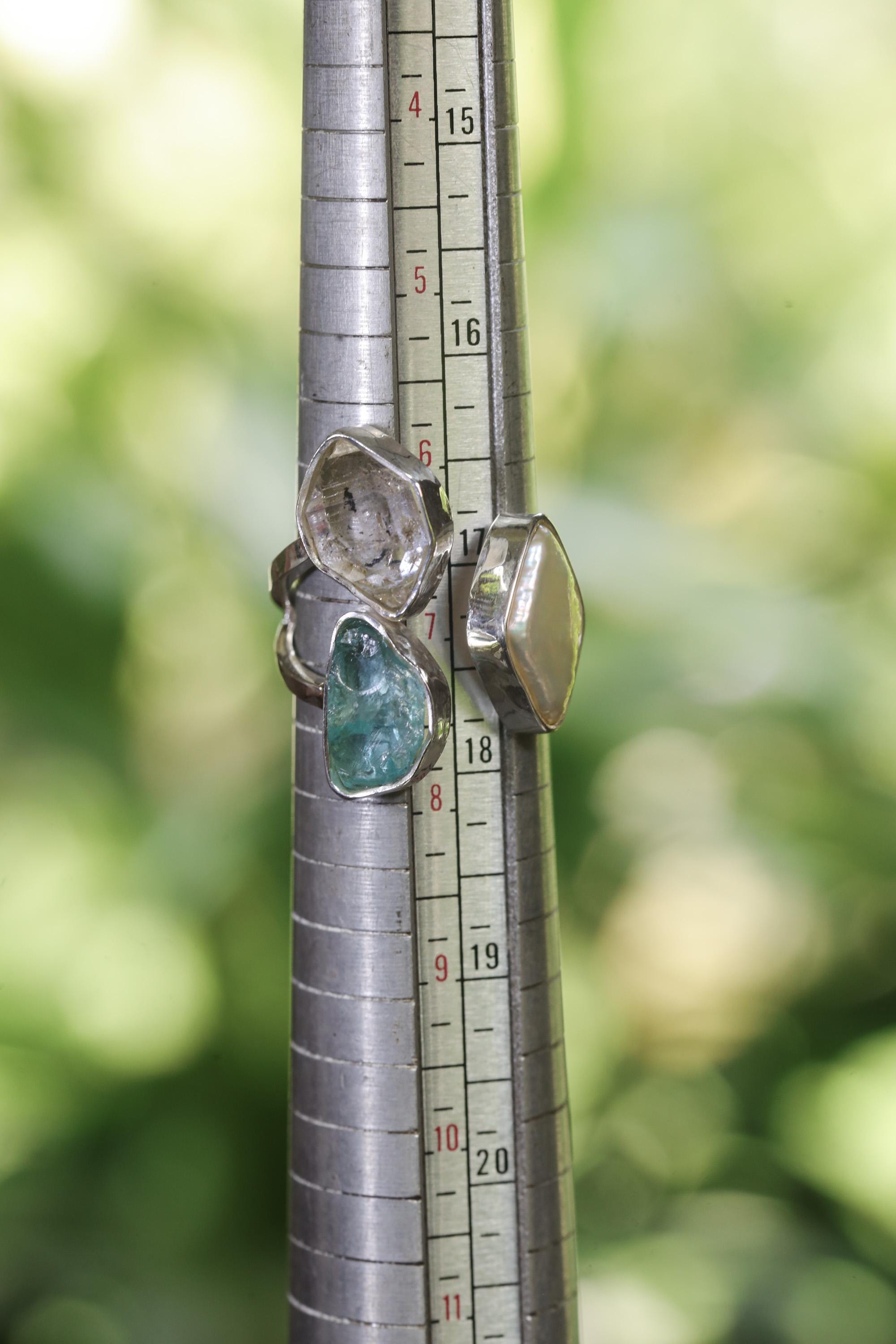 Herkimer Diamond Pearl Blue Apatite adjustable ring shown beside a ruler for scale in polished 925 sterling silver.