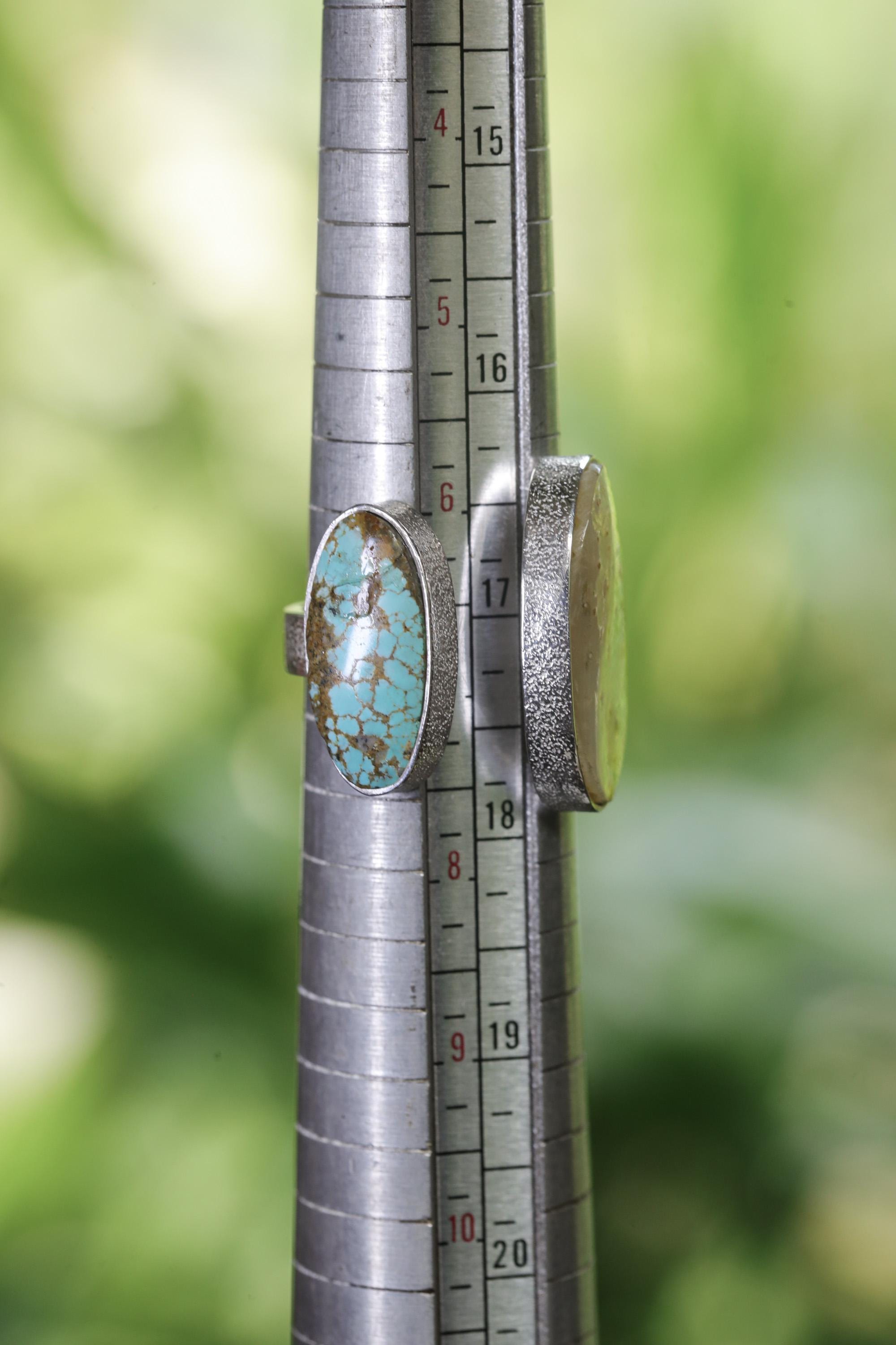 Mother of Pearl and Turquoise open ring shown on ring mandrel with approximate US size 5 to 10 range.
