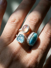 Triple stone Larimar Blue Apatite and Moonstone ring shown worn on hand with adjustable sterling silver band.