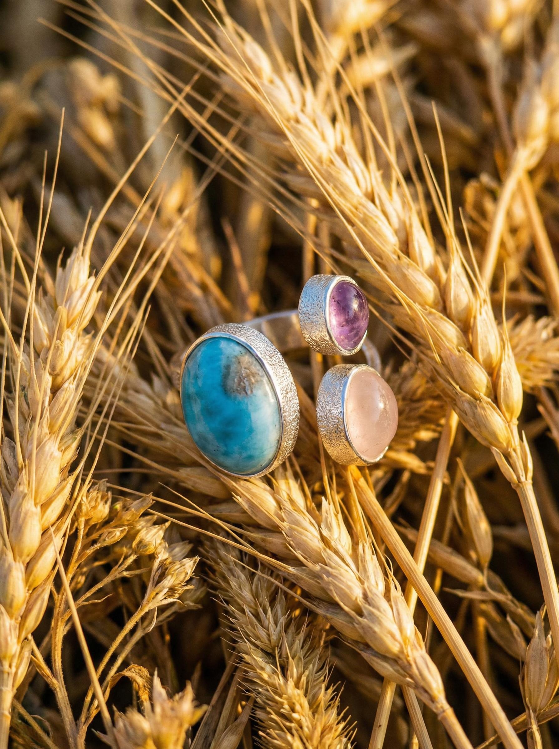 Ocean Heart Multi Stone Ring shown worn on outdoors with Larimar, Amethyst, Rose Quartz, and adjustable sterling silver band.