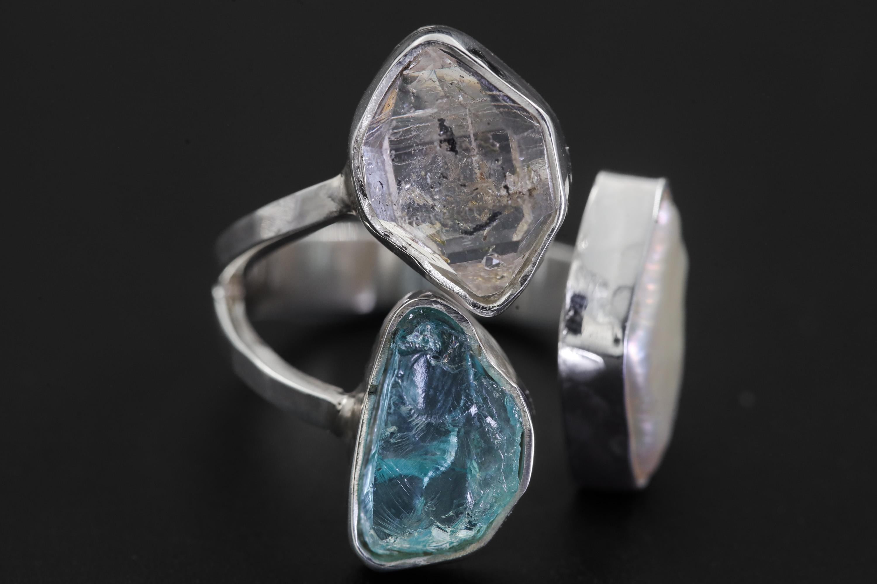 Macro detail of Herkimer Diamond, Blue Apatite, and Pearl bezel settings in a sculptural high-shine silver ring.