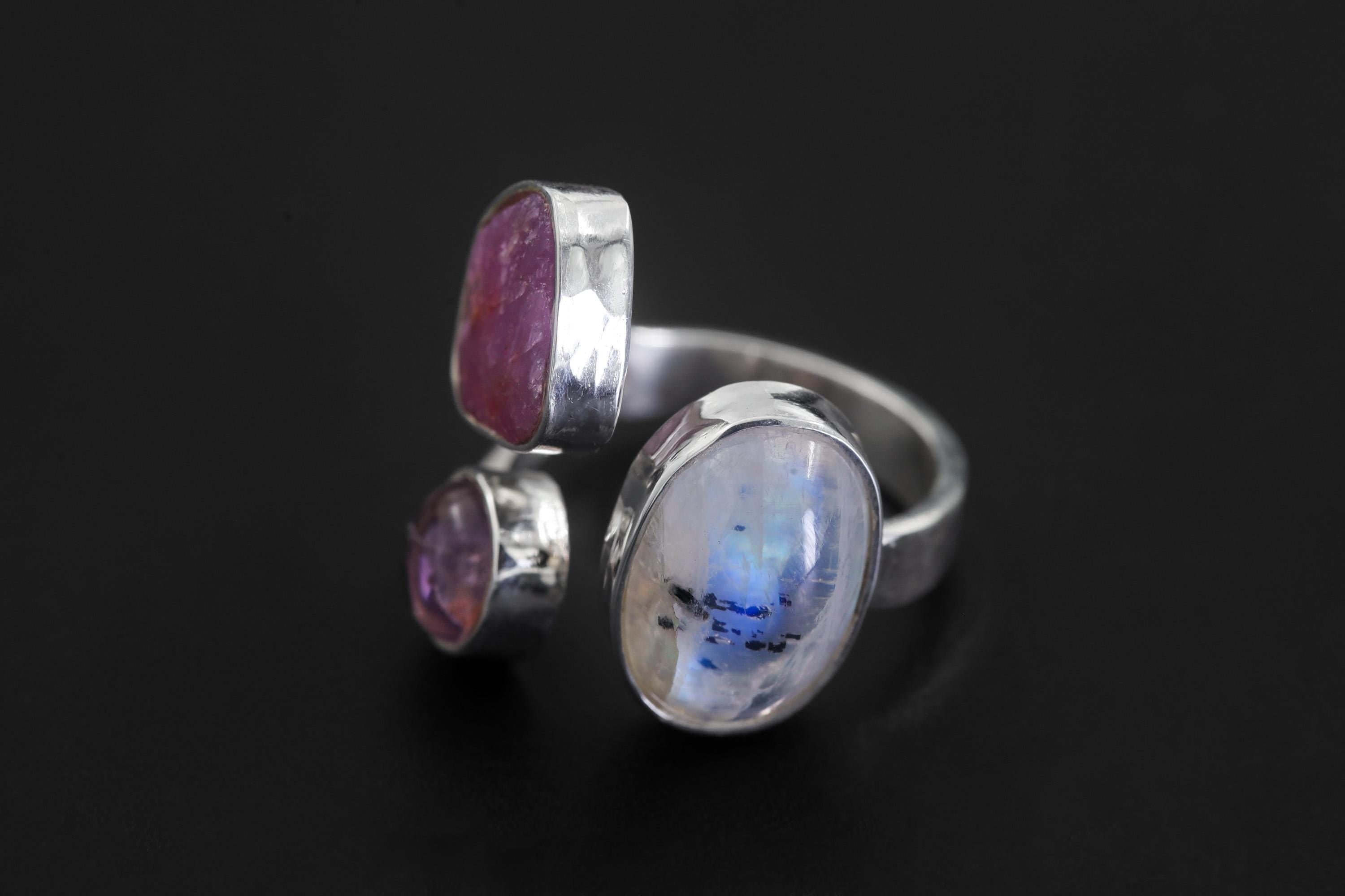 Inner Flame Multi Stone Ring shown worn on hand with Blue Moonstone, Ruby, Amethyst, and adjustable sterling silver band.