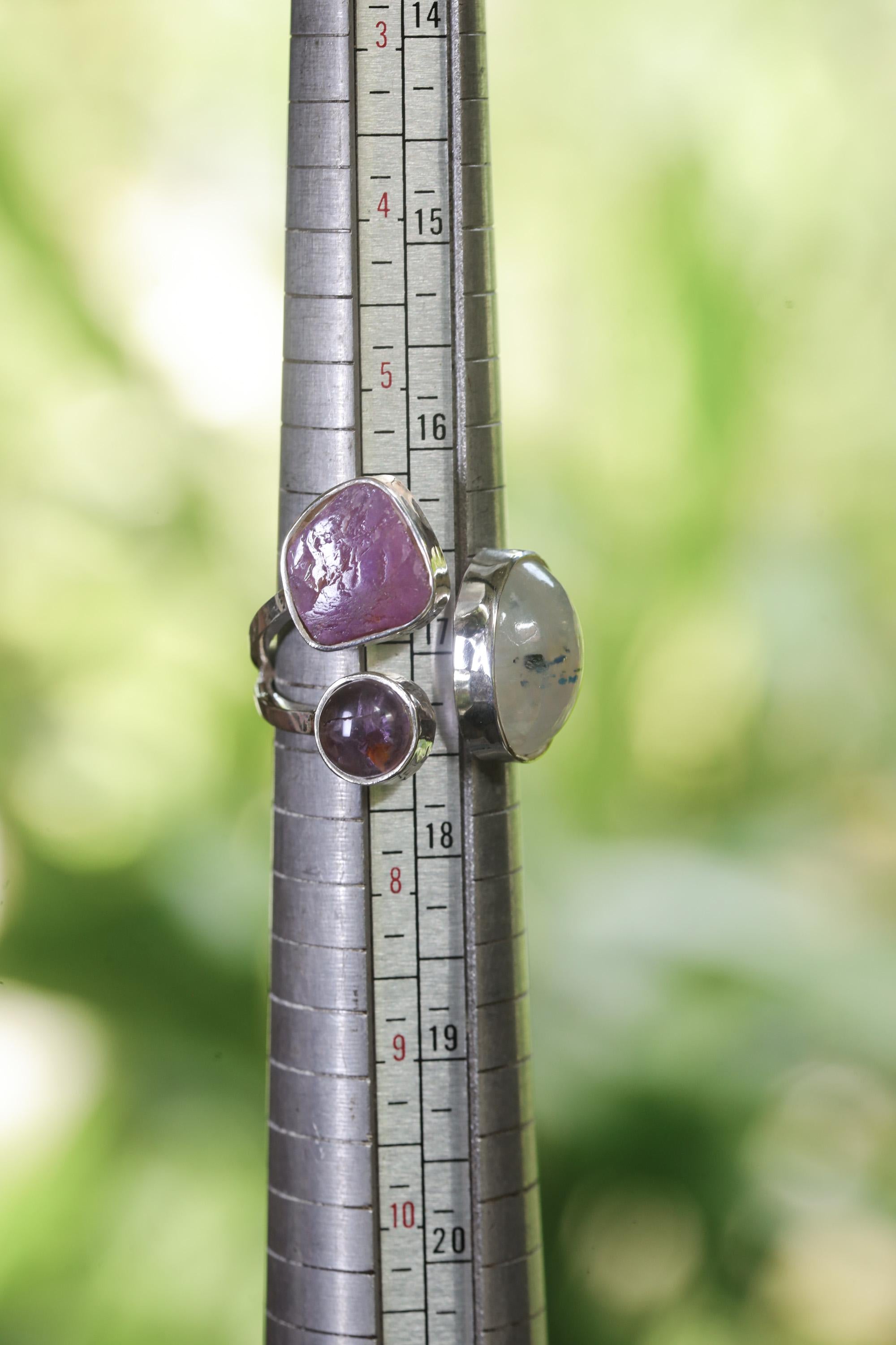 Inner Flame Multi Stone Ring shown beside a ruler for scale with Moonstone, Ruby, Amethyst, and open silver band.