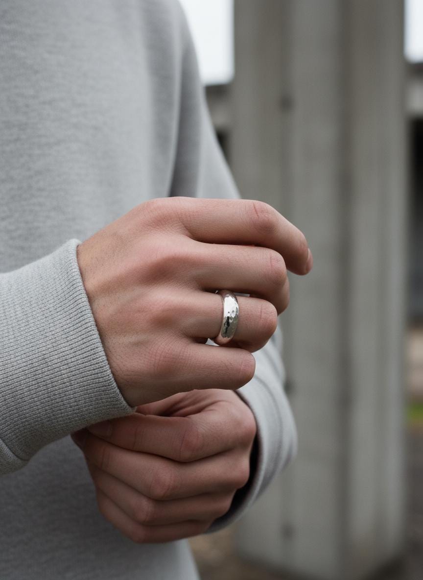 Sterling silver band shown worn on hand as a minimalist everyday ring.