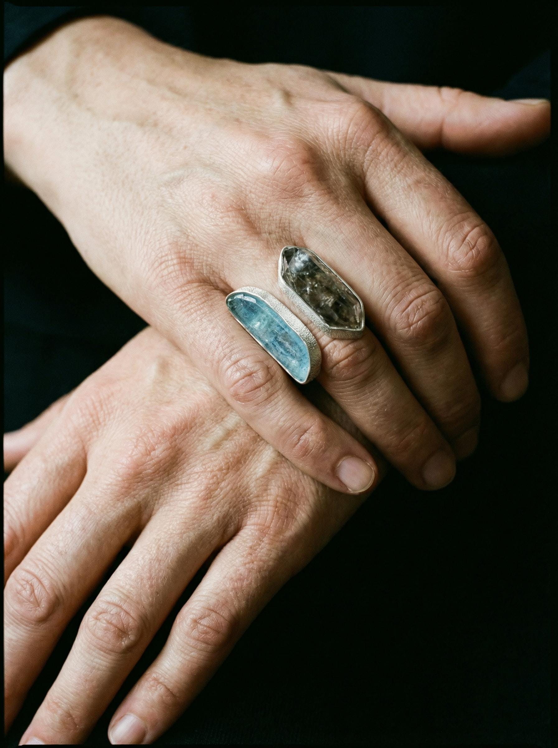 Tide and Shadow Smoky Quartz and Aquamarine Ring shown worn on hand with adjustable sterling silver dual stone setting.