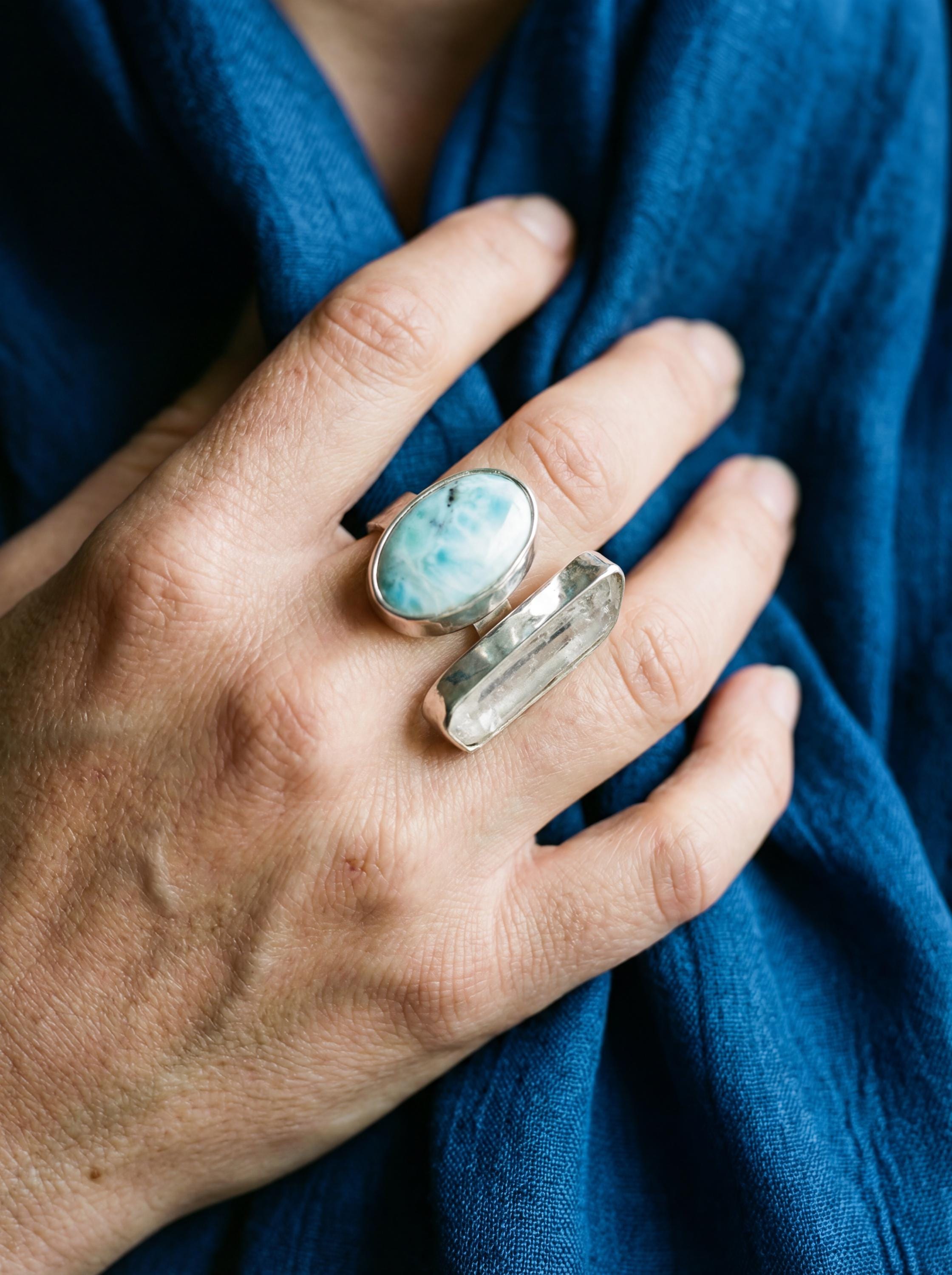 Horizon Flow Quartz and Larimar Ring shown worn with blue Larimar cabochon, Clear Quartz crystal, and polished silver band.