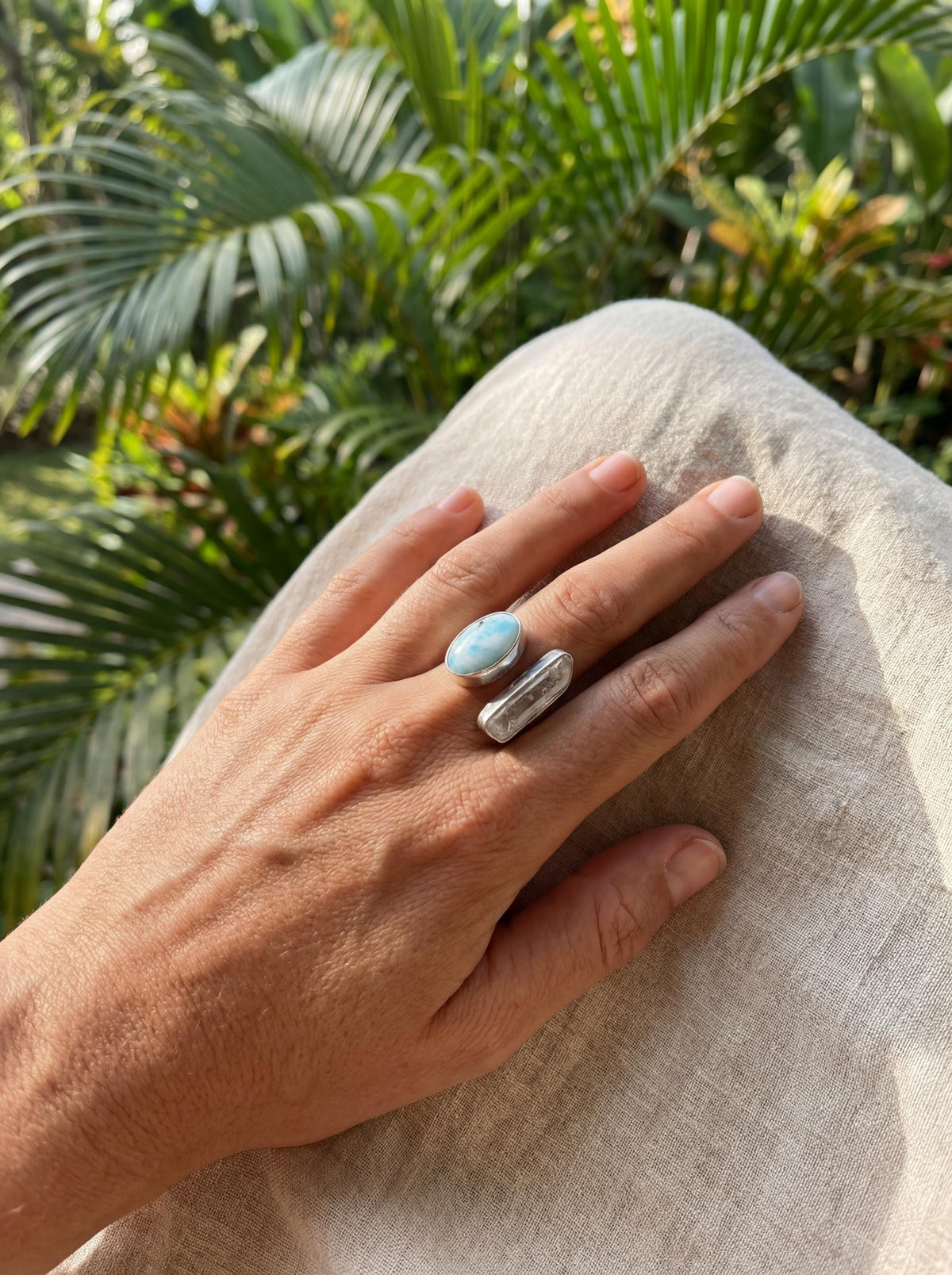 Horizon Flow Quartz and Larimar Ring shown worn on hand with adjustable sterling silver band and dual stone setting.