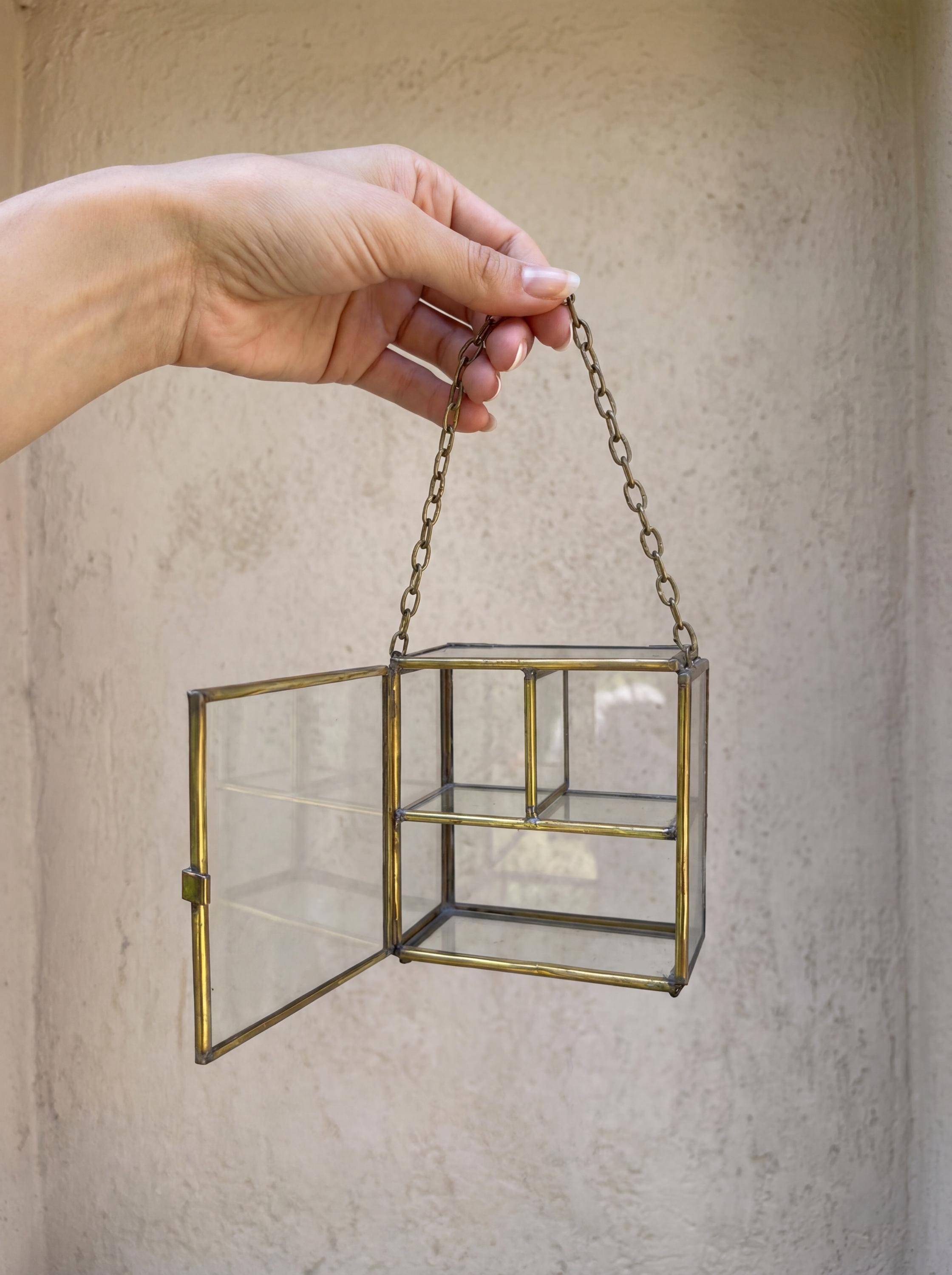 Large rectangular brass glass display box shown with open door and two internal levels for keepsake display.