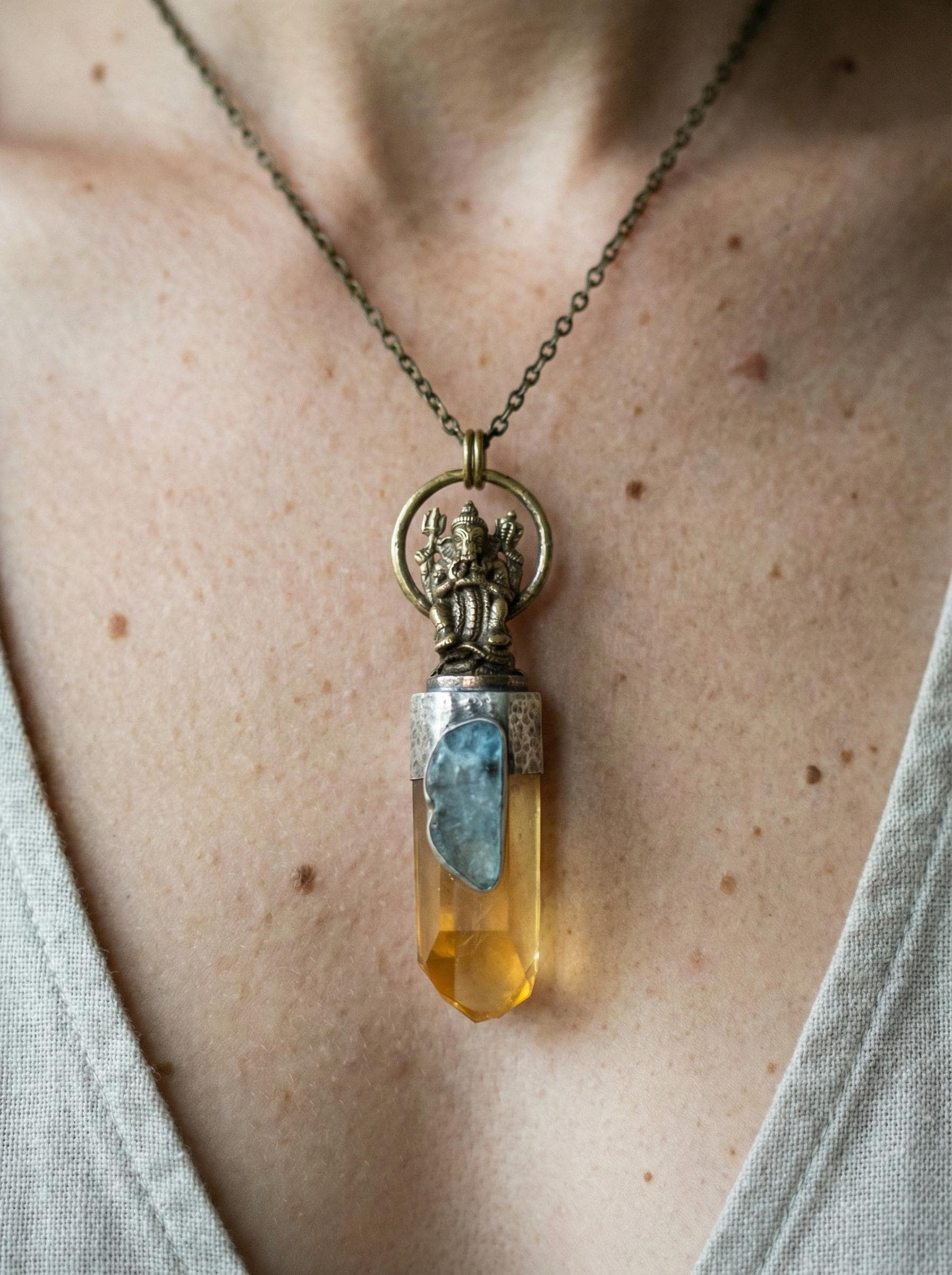 Ganesha Lemurian Quartz and Aquamarine talisman pendant shown worn as a sacred statement necklace.