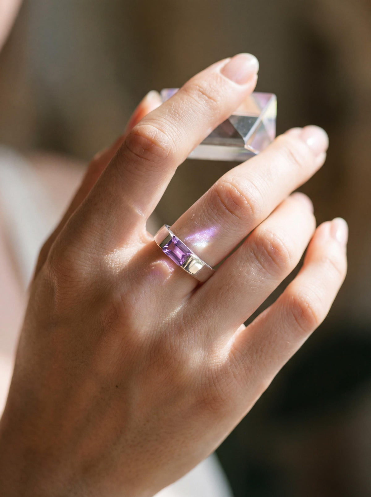 Octagon Amethyst sterling silver ring shown worn on hand with rich violet gemstone and polished band.