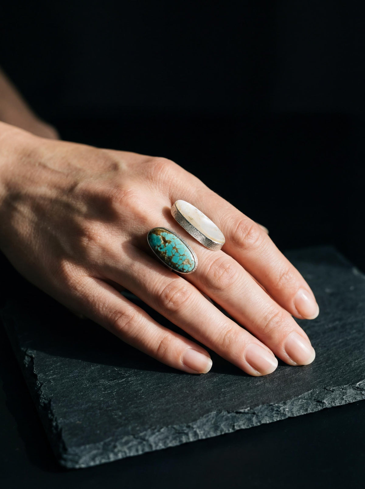 Mother of Pearl and Turquoise sterling silver open ring worn on hand with polished adjustable band.