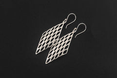 Sterling silver lattice earrings displayed on dark stone with open diamond-shaped geometric design.