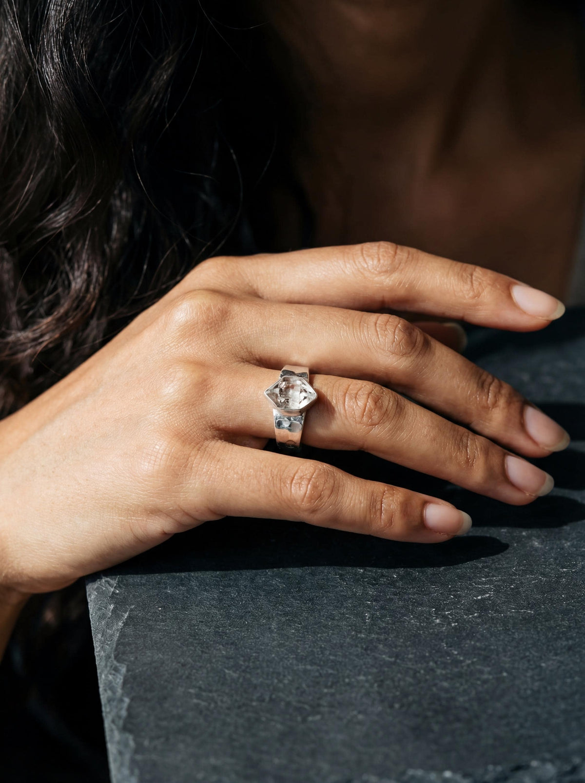 Crystal Clarity Herkimer Diamond Ring shown worn on hand with hammered sterling silver band and raw clear Quartz crystal.
