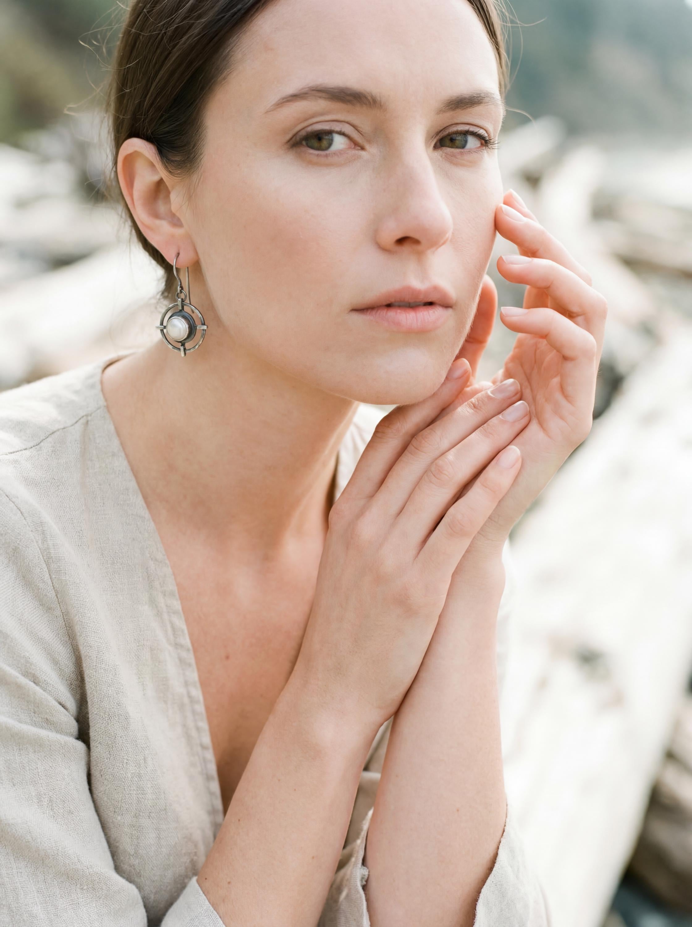 Old World Pearl statement earring shown worn on the ear, with luminous Pearl and textured sterling silver frame.