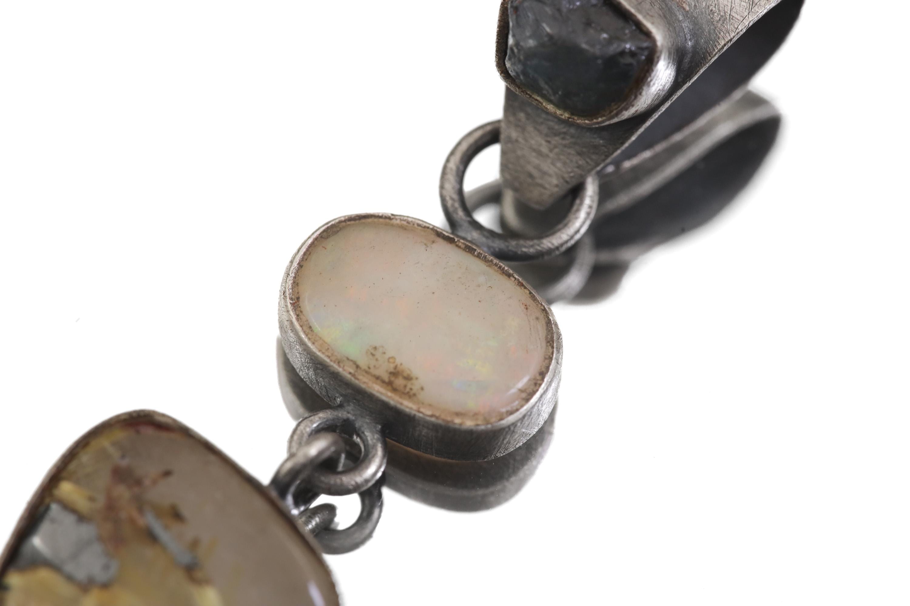 Close view of Sapphire Opal Rutile Quartz pendant showing brushed oxidized silver and layered stone design.