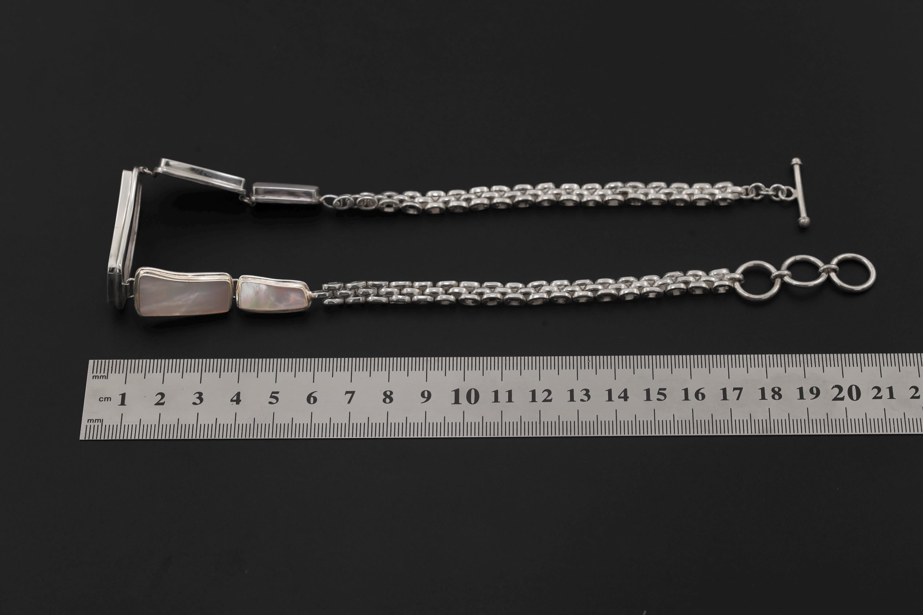 Mother of Pearl sterling silver necklace shown beside a ruler for 36 cm plus extender length reference.