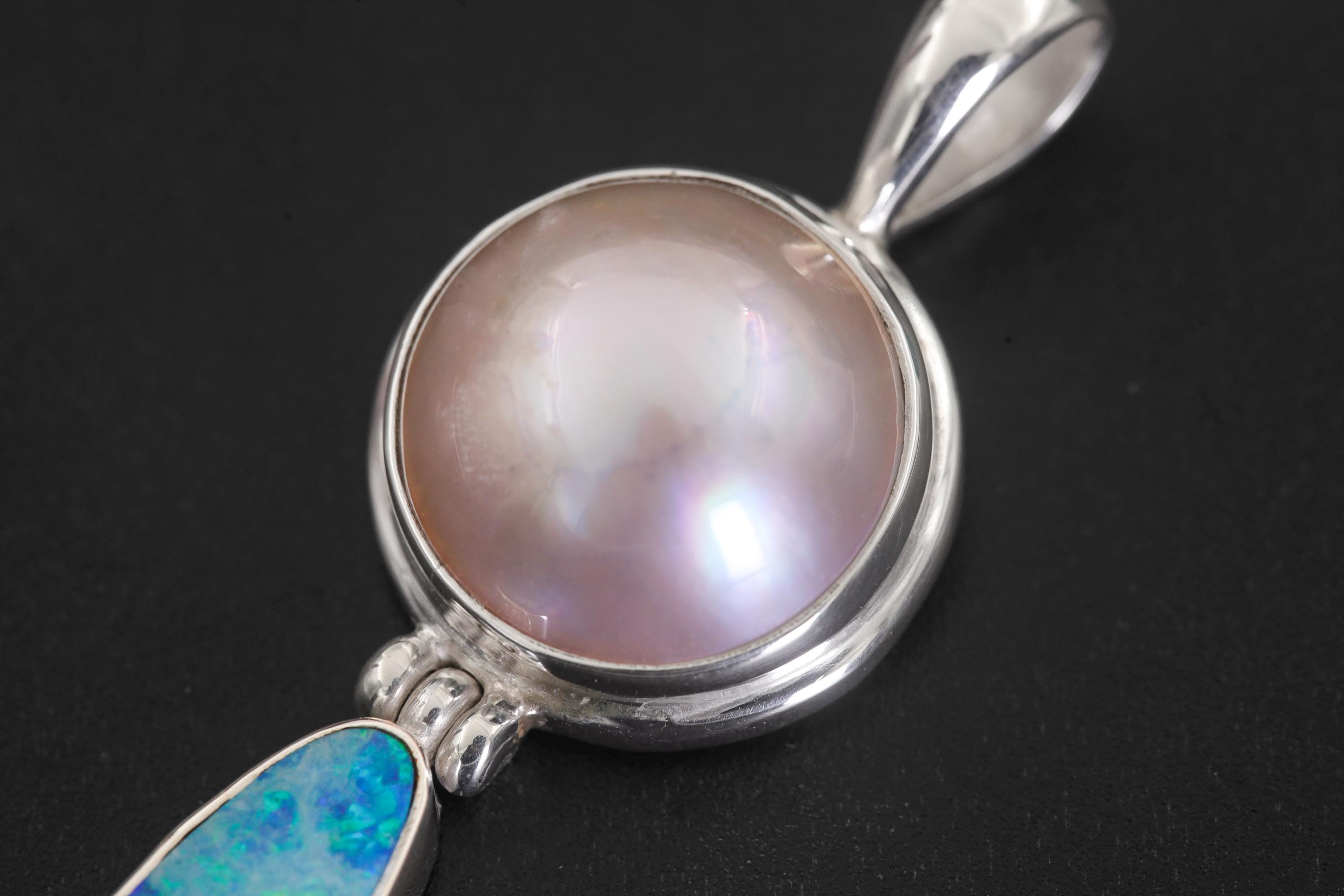 Close view of Pearl pendant top showing soft lustre in polished sterling silver bezel.
