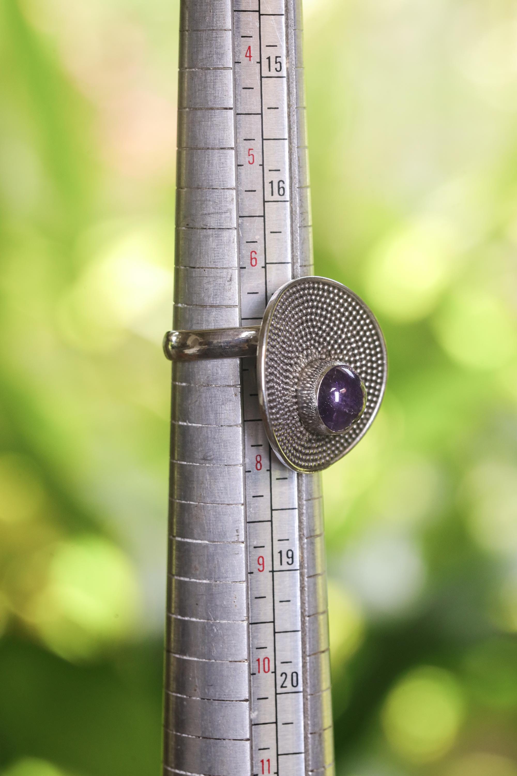 Amethyst adjustable sterling silver ring shown on mandrel Size 7 US  for approximate size range reference.