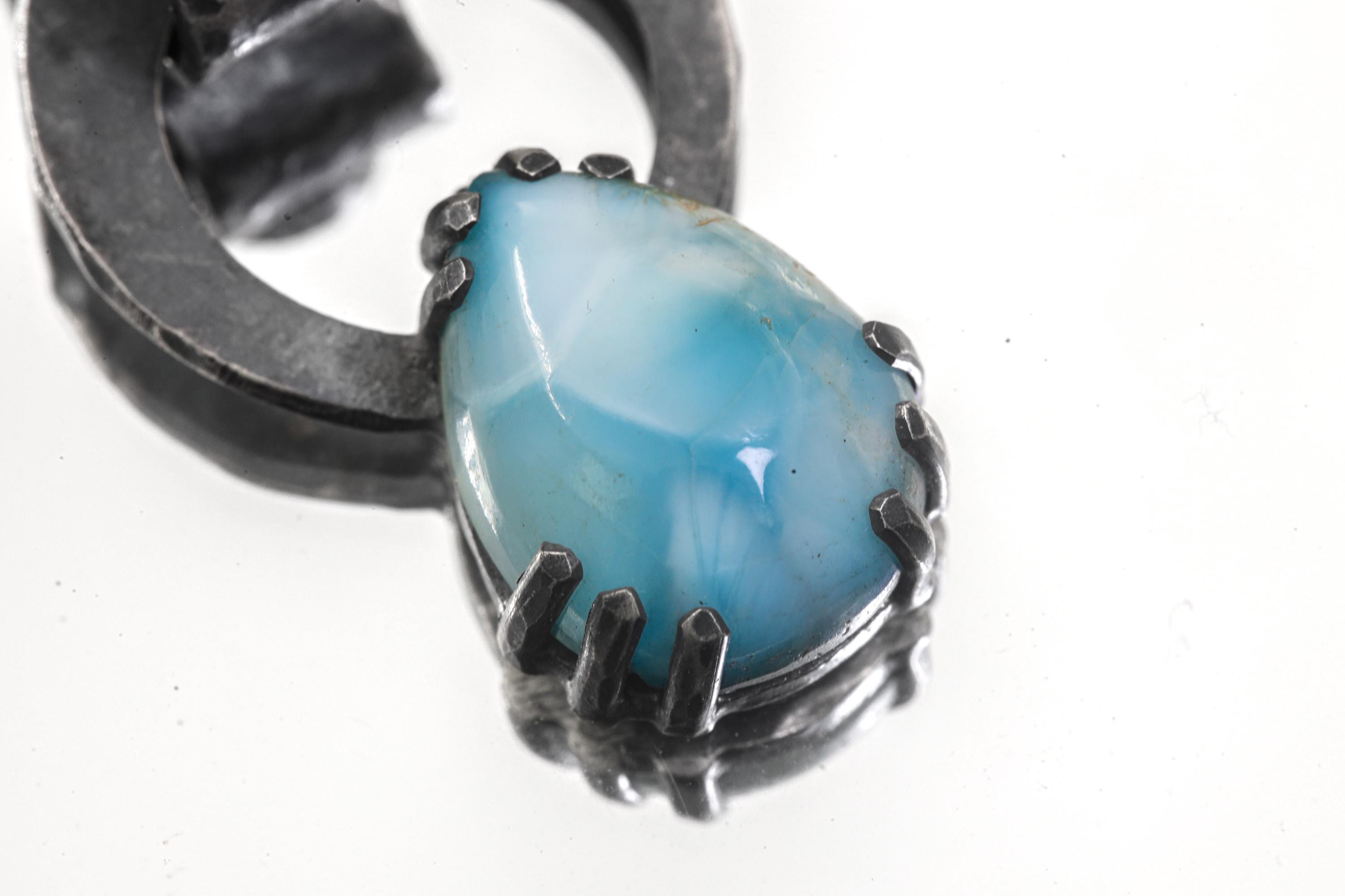 Close-up of Blue Moonstone accent set above Larimar in oxidized sterling silver pendant.