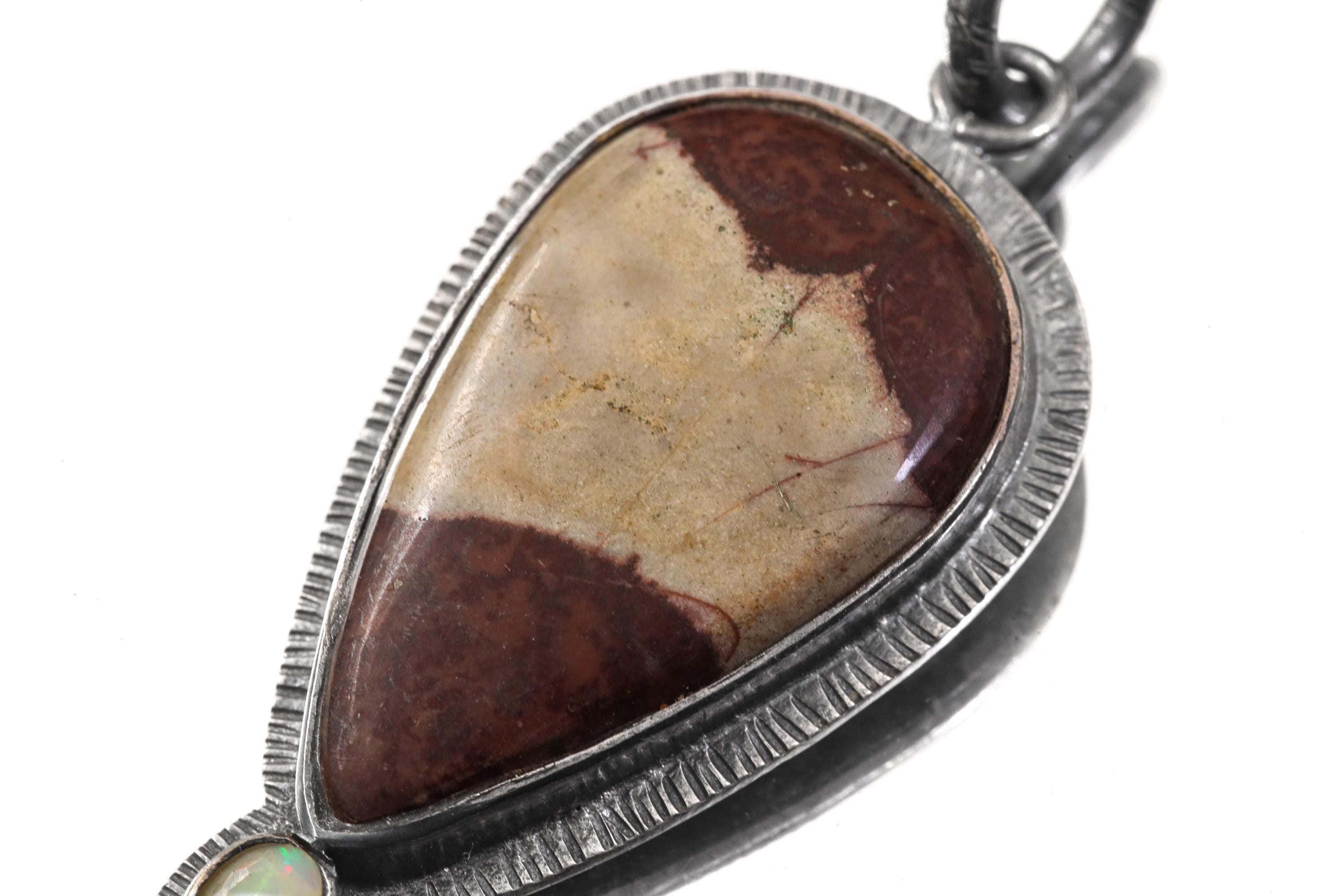 Close-up of Australian Mookaite pendant showing earthy cream and burgundy patterning in silver frame.
