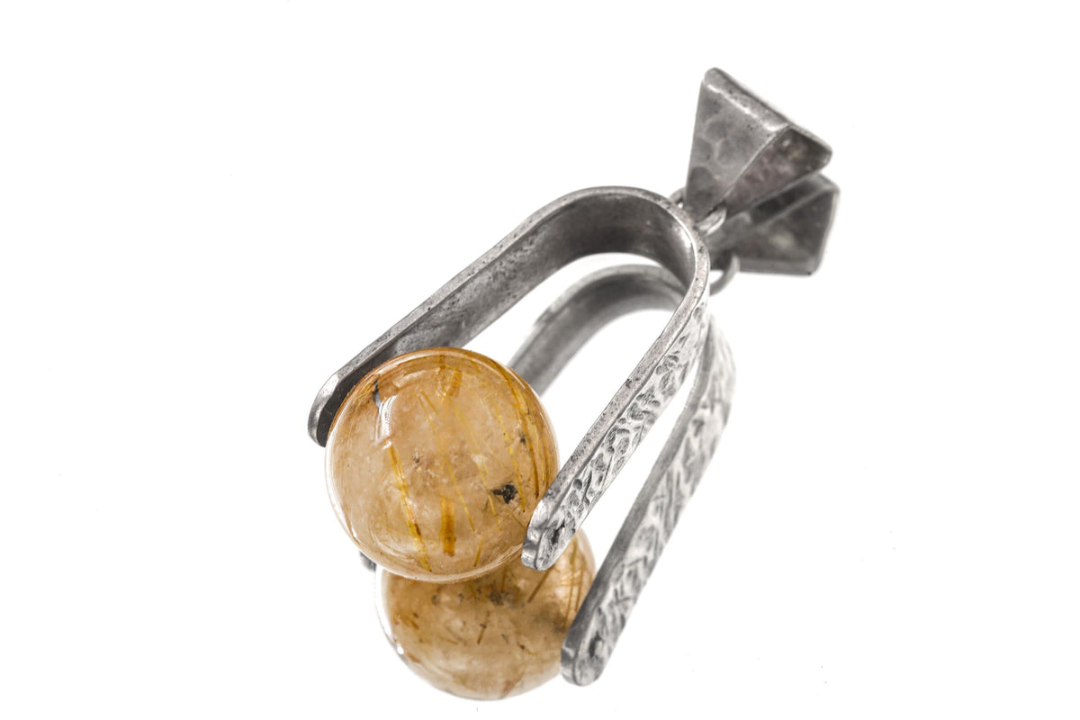 Golden Rutilated Quartz spinning pendant displayed in handmade sterling silver setting.