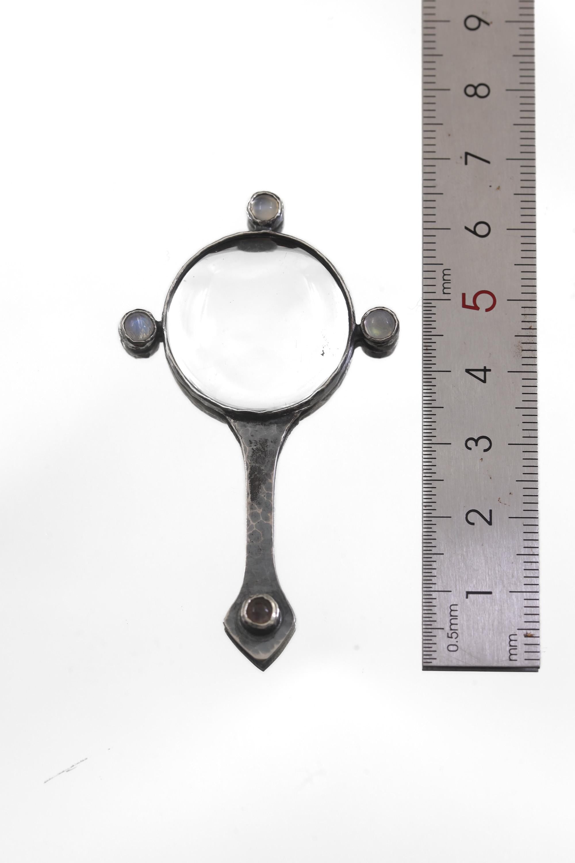 Moonstone magnifier pendant shown beside a ruler for statement pendant size reference.