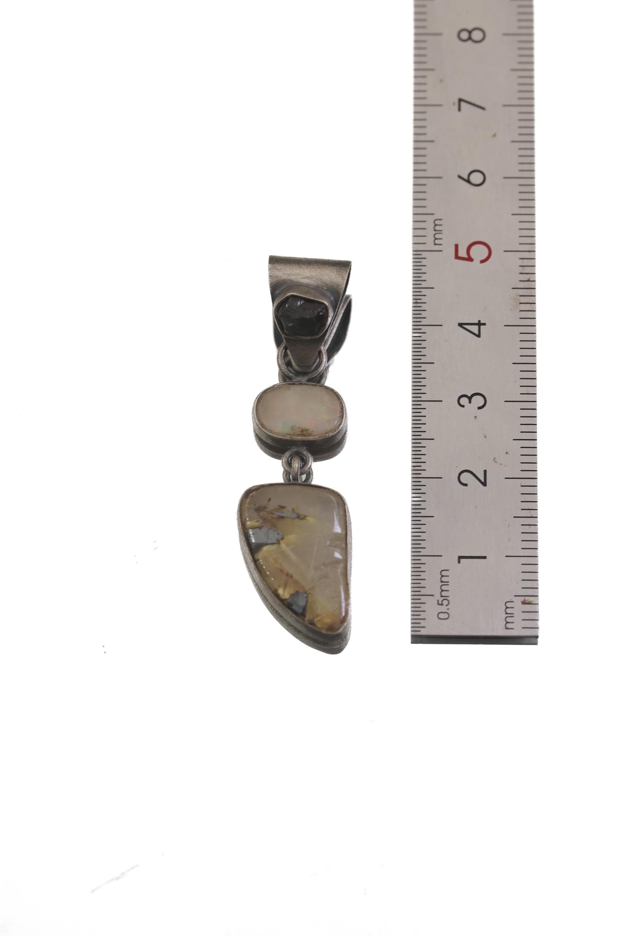 Sapphire Opal Rutile Quartz pendant shown beside a ruler for approximately 6 cm length reference.