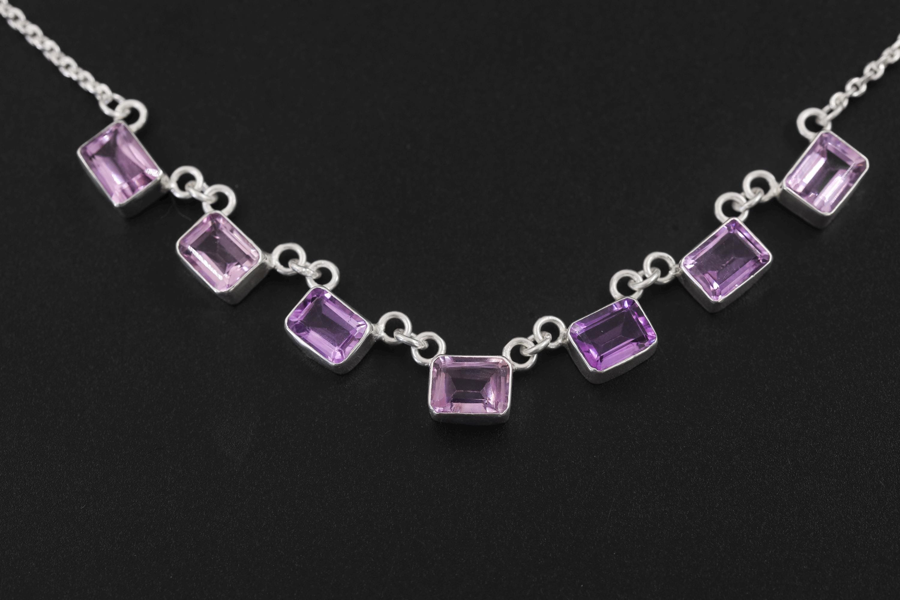 Close view of square Amethyst necklace showing lilac and violet stones in polished sterling silver bezels.
