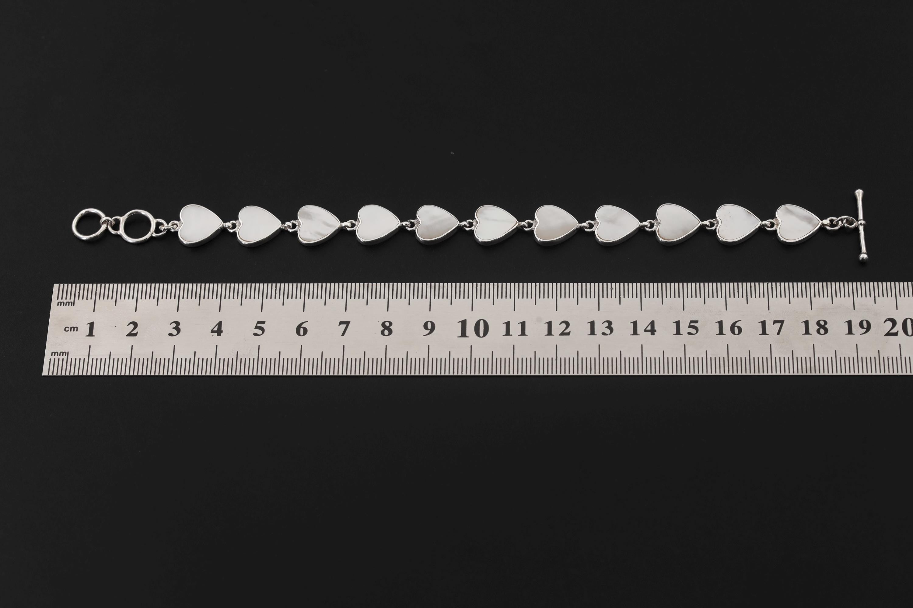 Mother of Pearl sterling silver bracelet shown beside a ruler for 19 cm length reference.