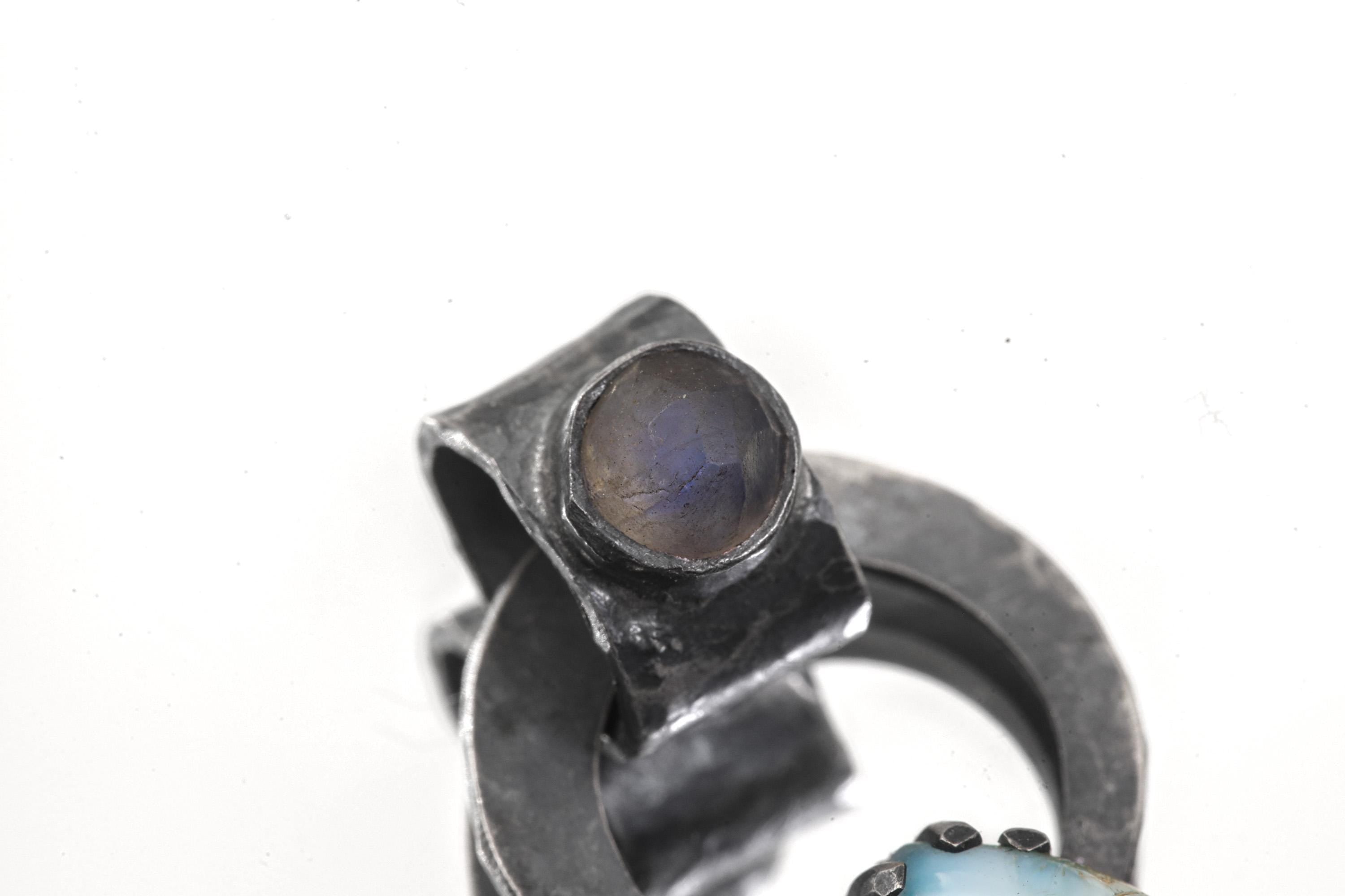 Larimar Blue Moonstone pendant worn on a silver choker with oxidized circular setting and blue teardrop stone.