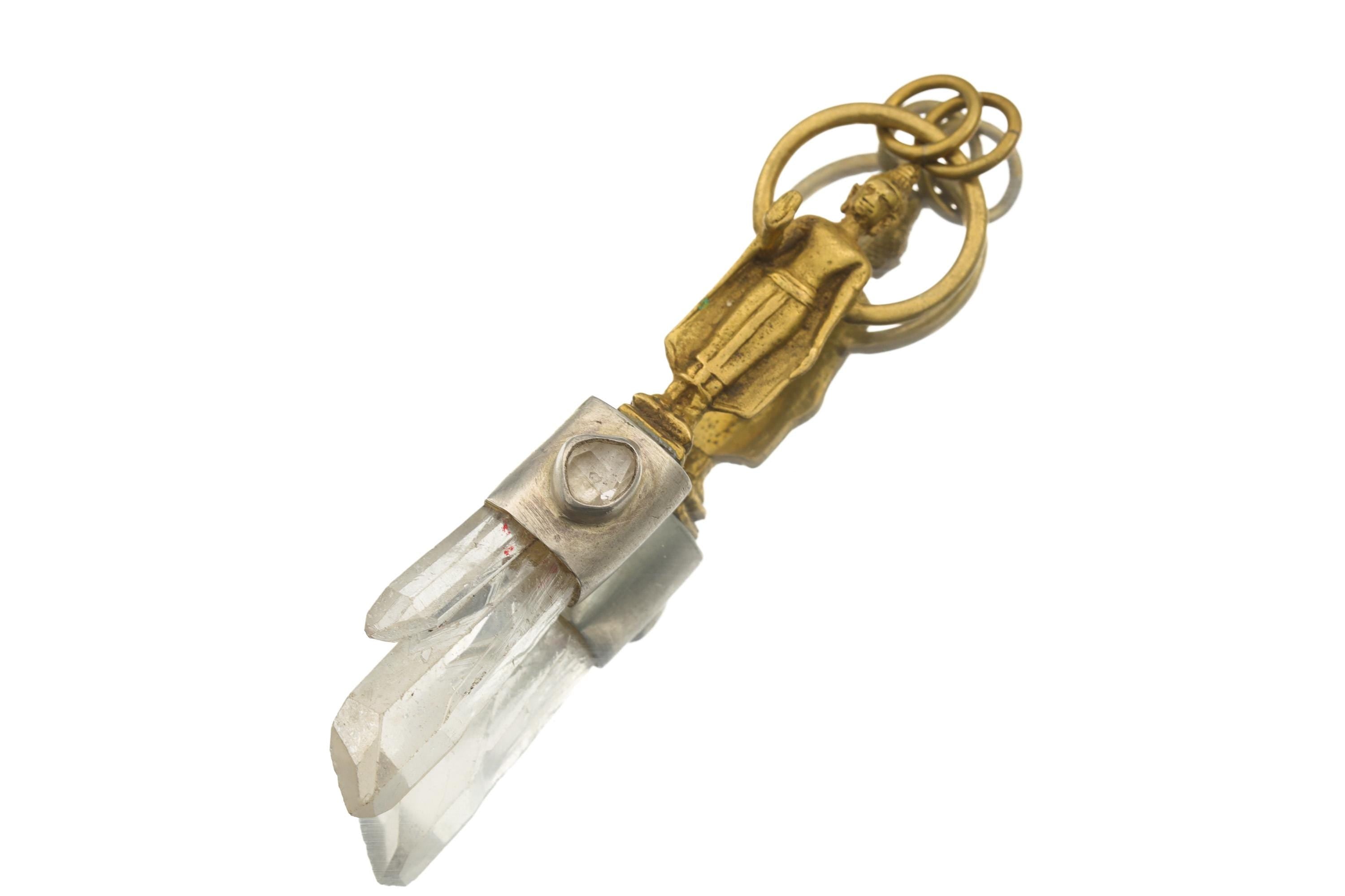 Close-up of brass Buddha figure above Himalayan Twin Quartz and Herkimer Diamond in a brushed sterling silver pendant.