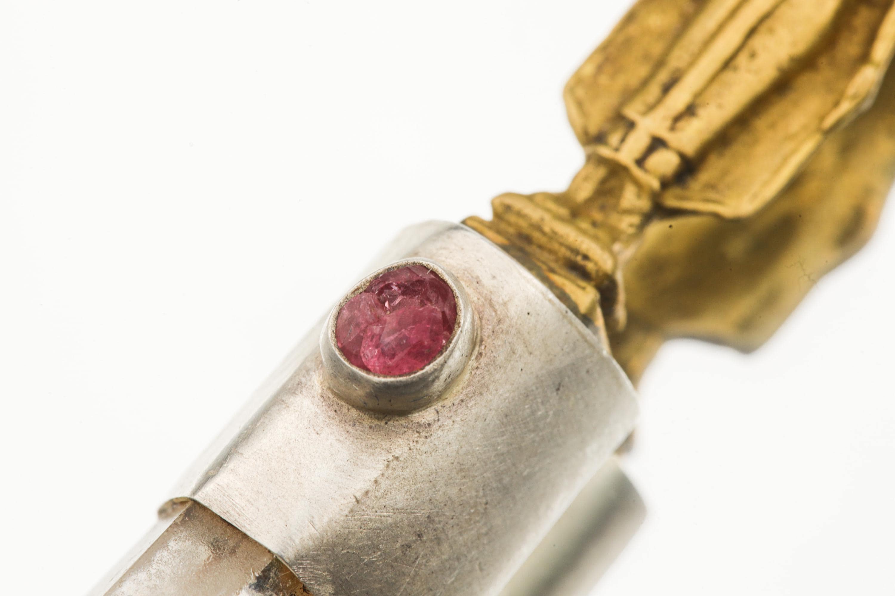 Close-up of Ruby accent set above Clear Quartz in a symbolic Buddha talisman pendant.