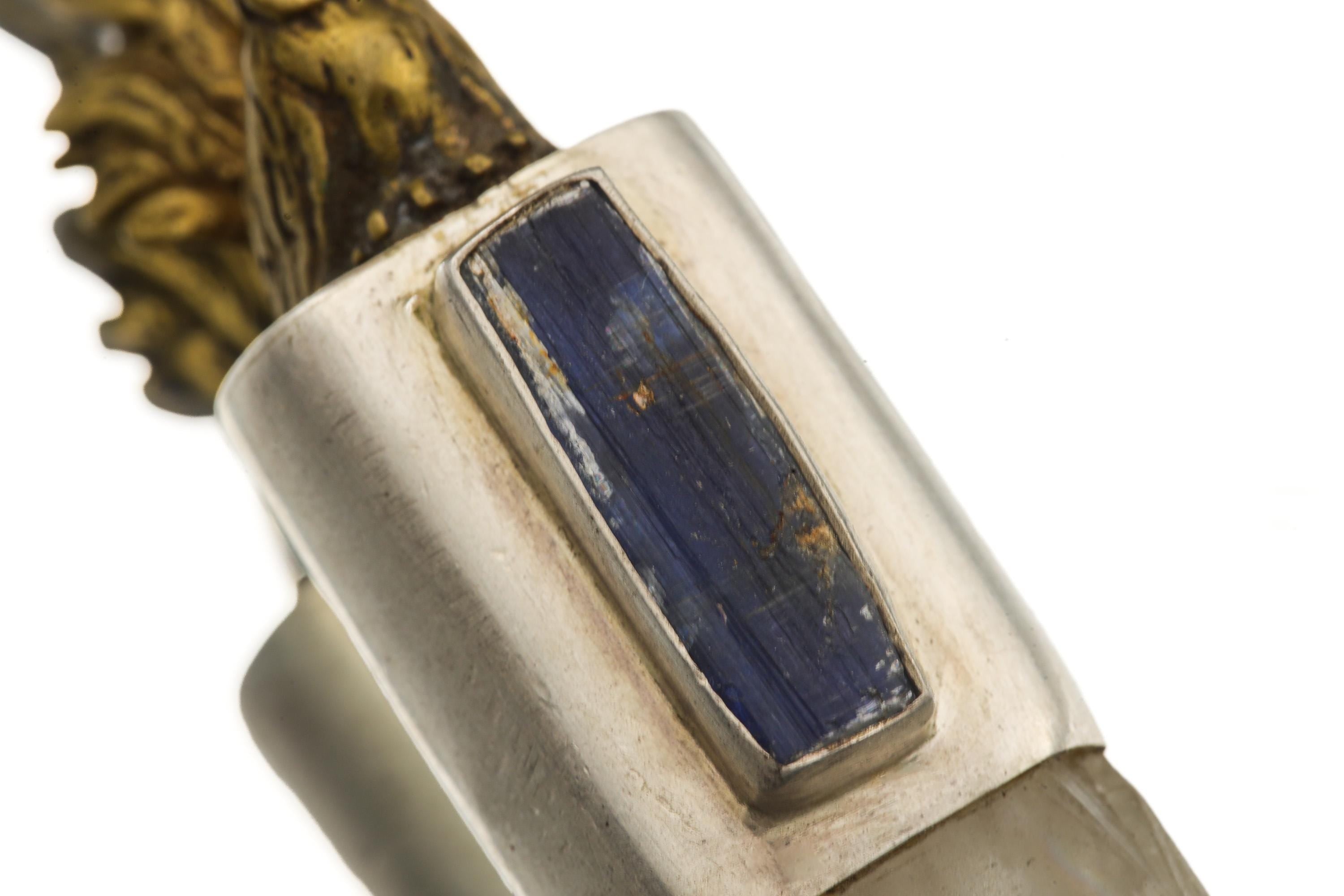 Close-up of raw deep blue Kyanite set beside Himalayan Twin-Terminated Clear Quartz in a sterling silver pendant.
