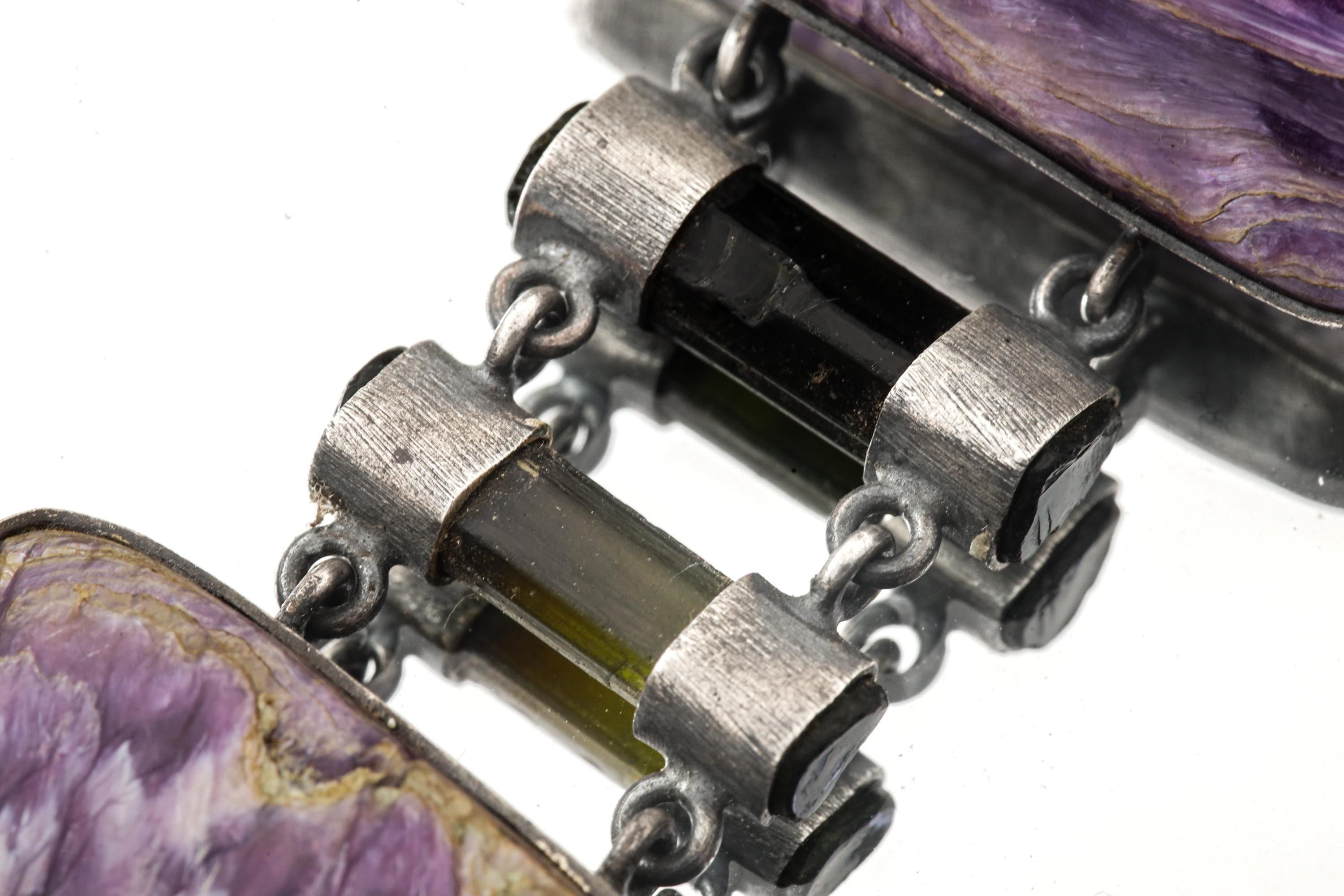 Close-up of Charoite and Black Tourmaline bridge stones in a heavy handmade sterling silver statement pendant.