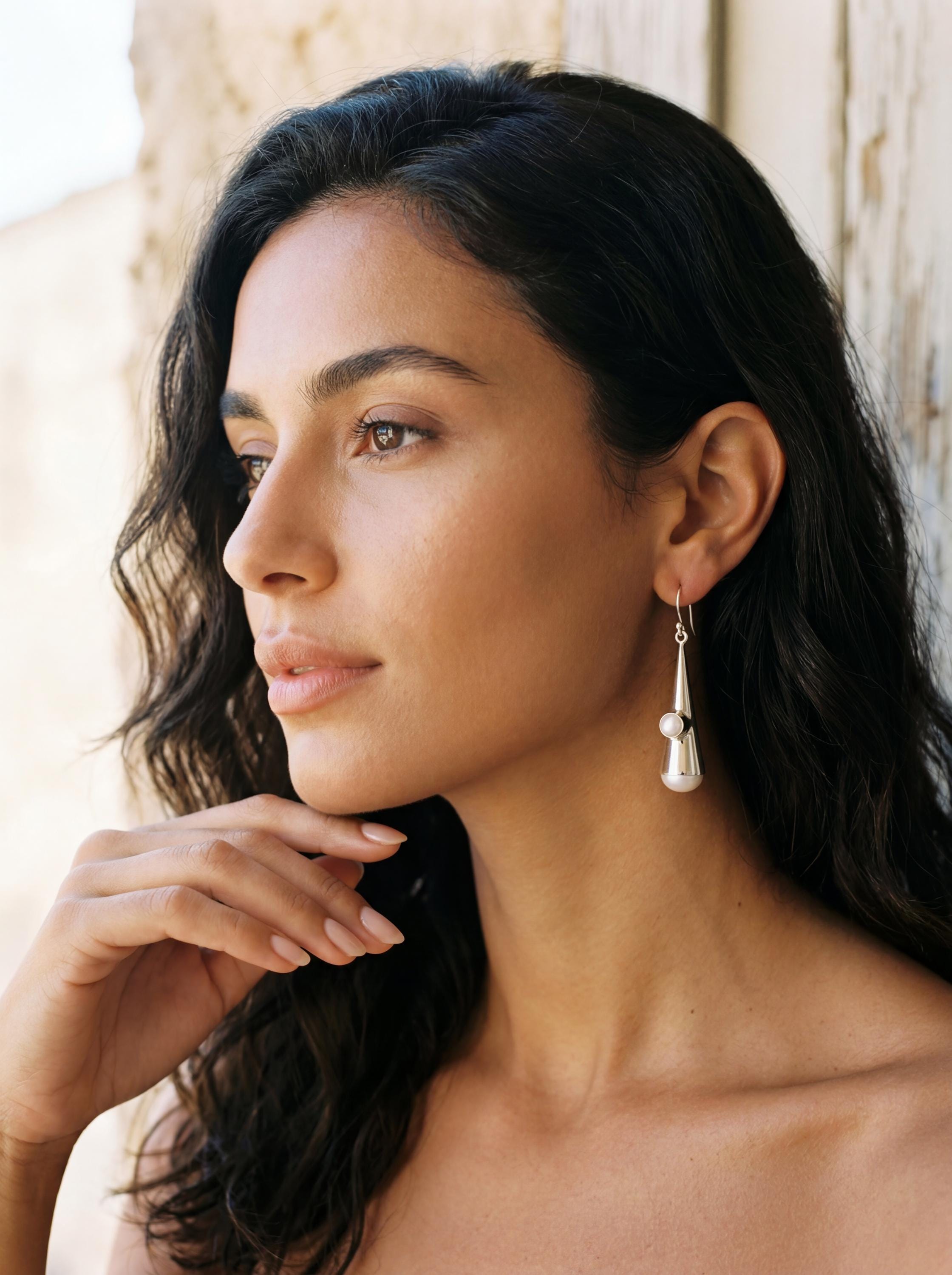 Pearl cone earrings shown worn on model as elegant sculptural sterling silver drops.