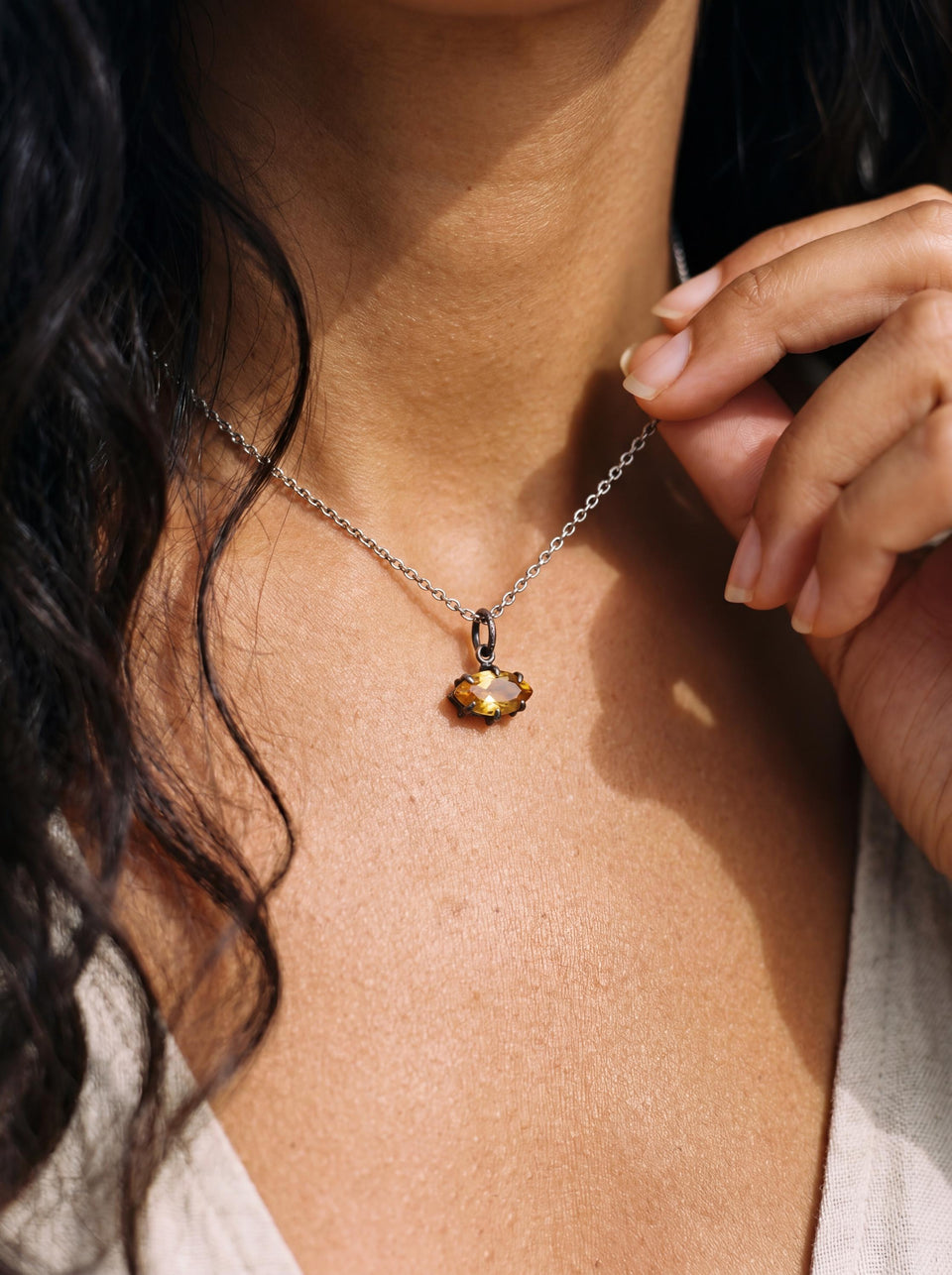 Citrine marquise pendant shown worn as a petite oxidized silver gemstone necklace.