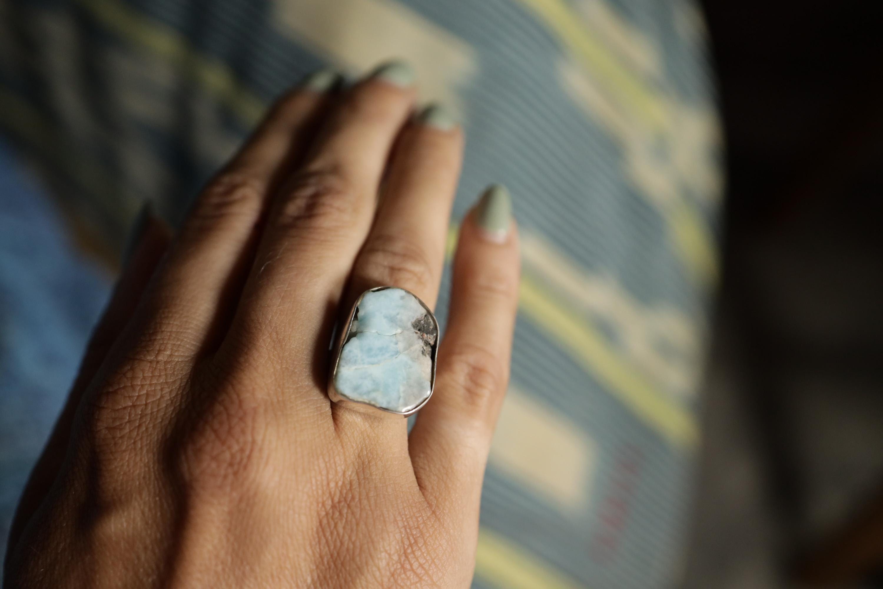 Larimar ring shown worn on the hand as a soft ocean-blue Throat Chakra gemstone ring in handmade silver.