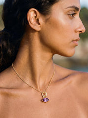 Amethyst marquise pendant shown worn on model as a petite gold-plated crystal charm.
