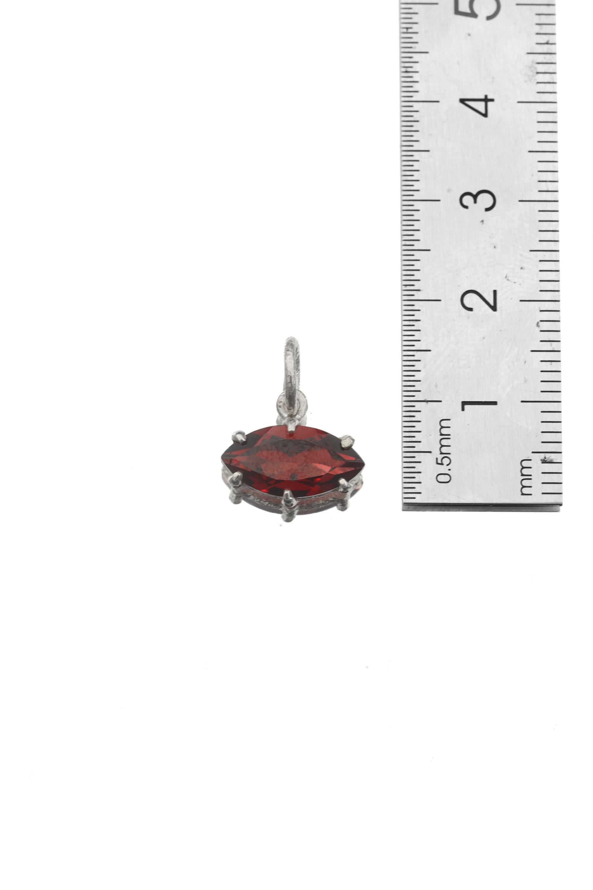 Garnet marquise pendant shown beside ruler for petite gemstone pendant size reference.