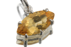Close view of faceted Citrine pendant in sterling silver claw setting with bright golden colour.