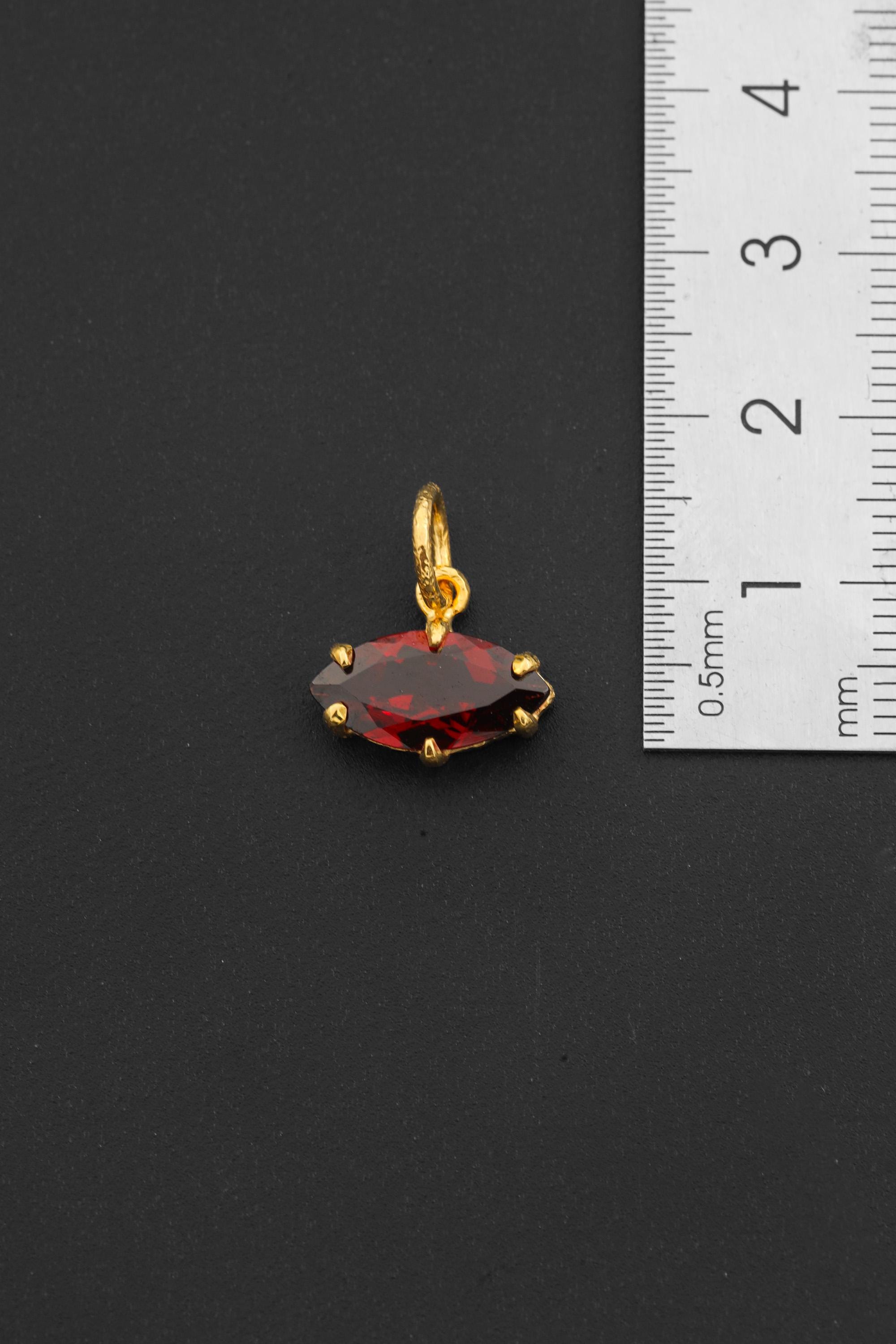 Gold-plated Garnet pendant shown beside a ruler for compact pendant size reference.