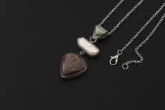 Shadow Tide Pearl pendant shown on dark background with South Sea Pearl and Black Rutile Quartz.