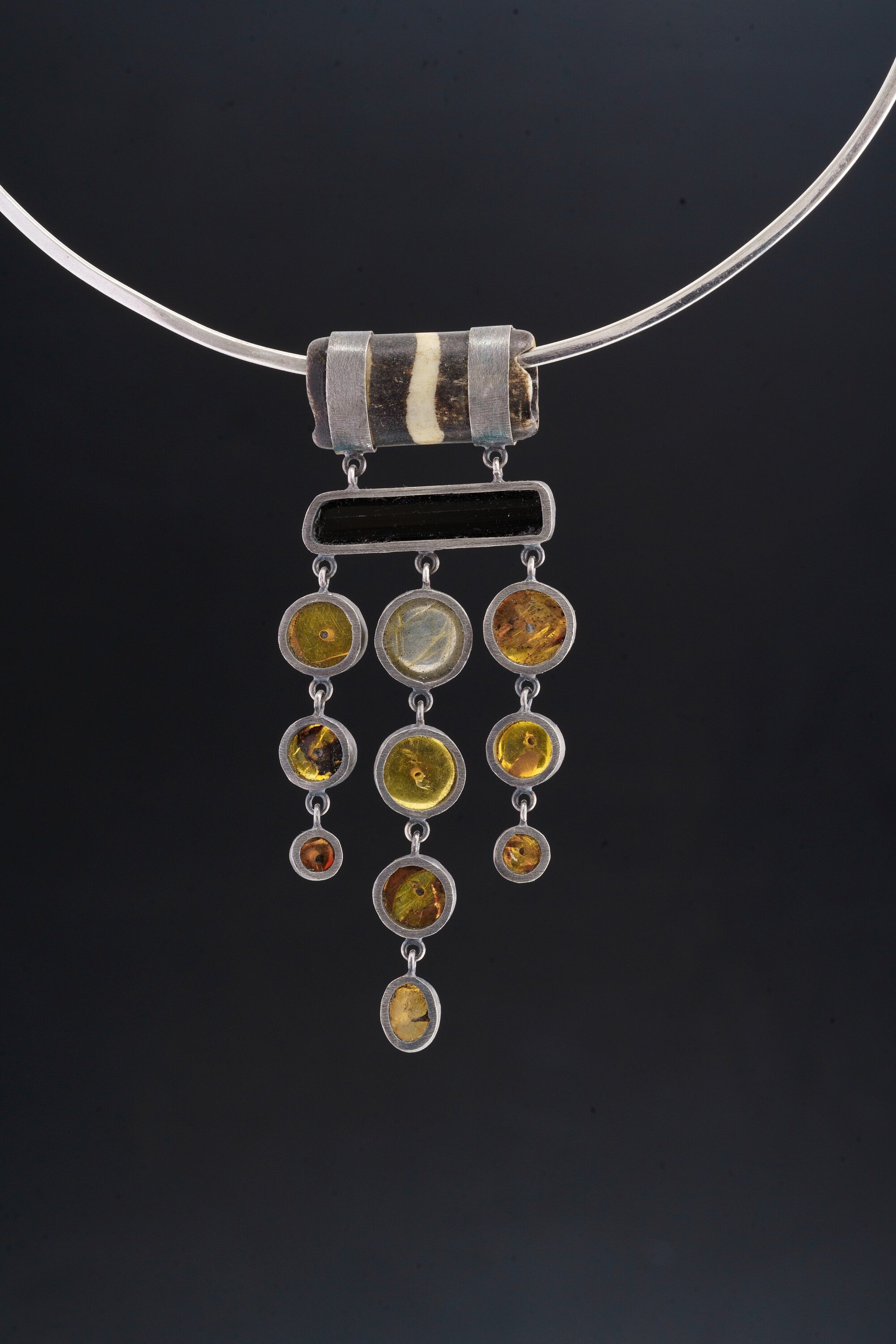 Ancestral Echoes: Carved Bone, Black Tourmaline, Mexican Amber, and Rainbow Labradorite - Sterling Silver Pendant